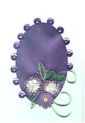 Quillling on purple metallic paper and sequin border
